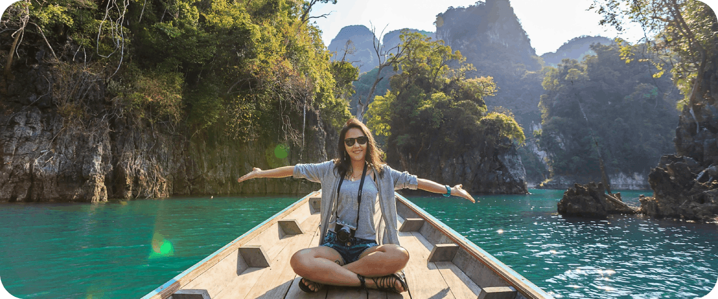 A woman sitting on the back of a boat in the water.